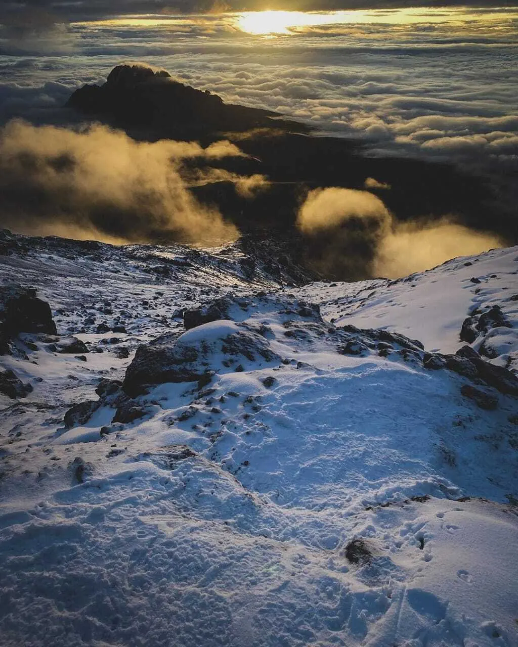 Trekkers above the clouds on Mount Kilimanjaro